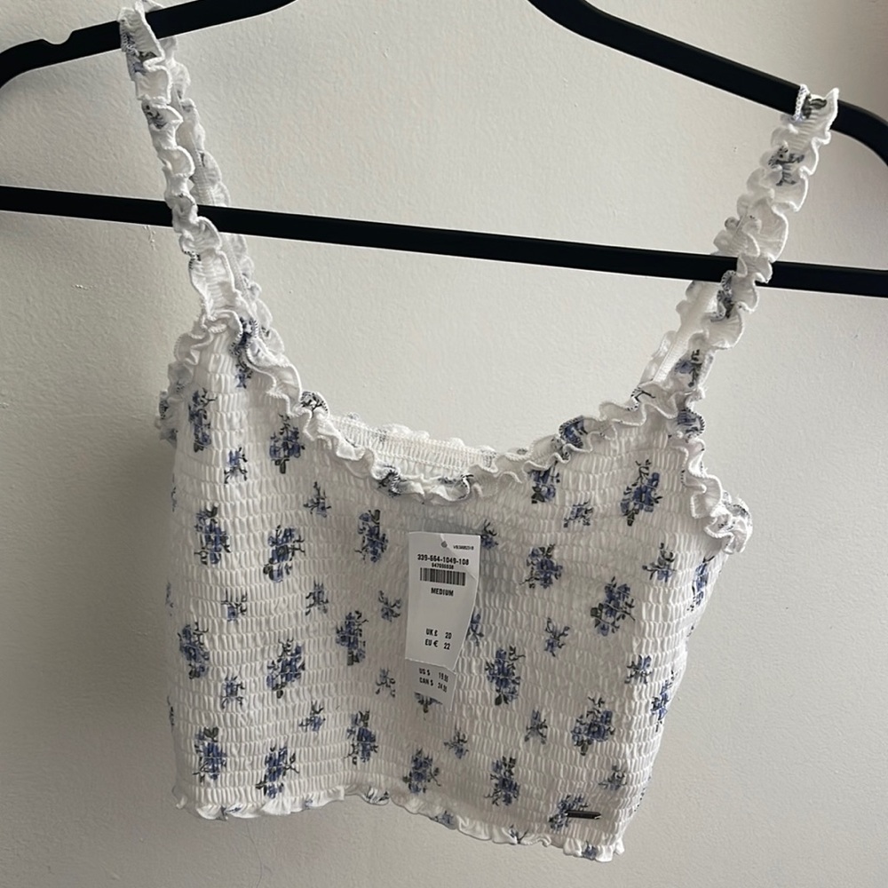 white and blue flowered crop tank